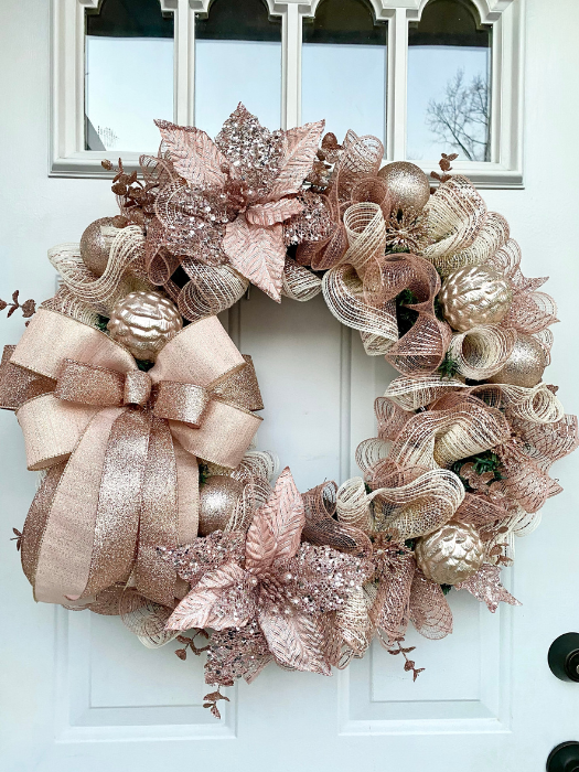 Rose Gold Wreath with poinsettias, ornaments mesh and bow all in rose gold
